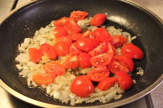 Saute onions and garlic, then add tomatoes.