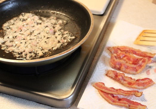 Bacon crisped, shallots being sautéed