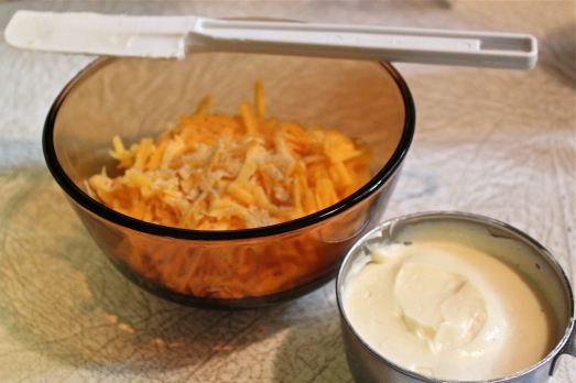 Mix together mayonnaise and shredded cheese.